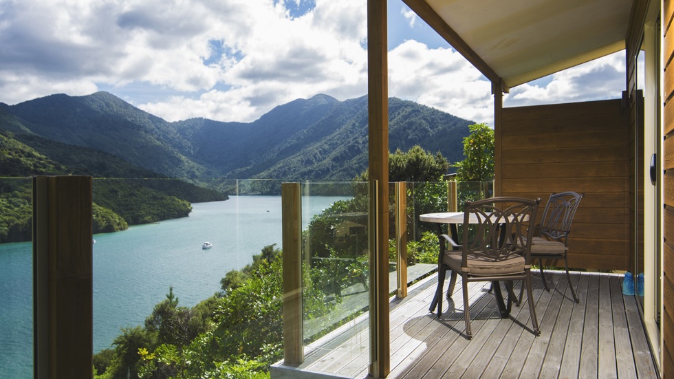 The private furnished balcony of a Frond Suite at Punga Cove has sweeping views across Endeavour Inlet in the Marlborough Sounds, New Zealand