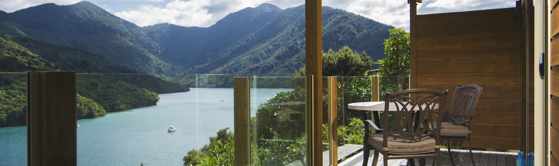 The private furnished balcony of a Frond Suite at Punga Cove has sweeping views across Endeavour Inlet in the Marlborough Sounds, New Zealand