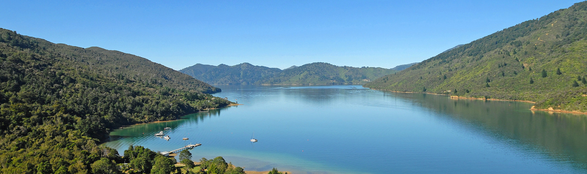 An aerial view of Endeavour Inlet, with Furneaux Lodge in the foreground, in the outer Queen Charlotte Sound/Tōtaranui, Marlborough Sounds, New Zealand.