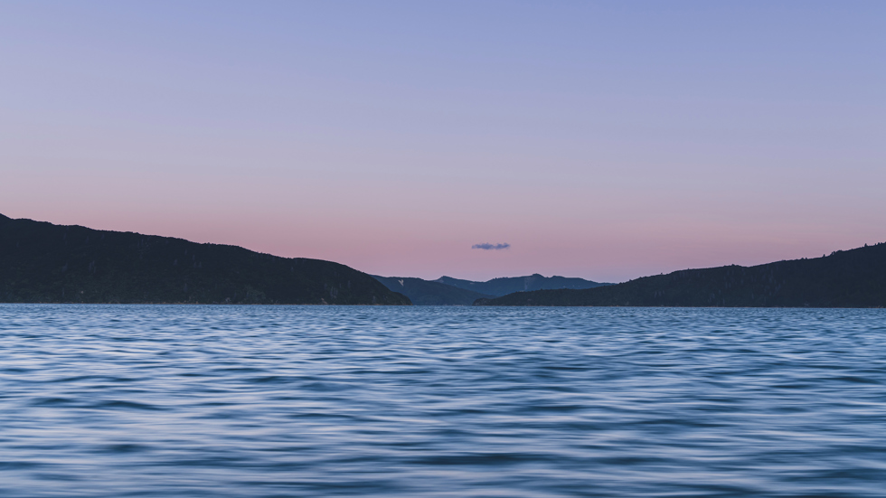 The Marlborough Sounds water, hills and full moon at sunset, Marlborough, New Zealand.