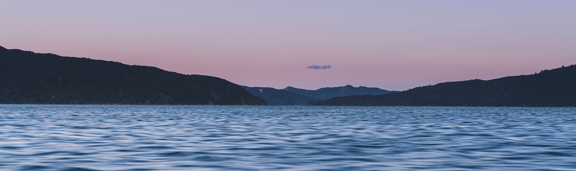 The Marlborough Sounds water, hills and full moon at sunset, Marlborough, New Zealand.