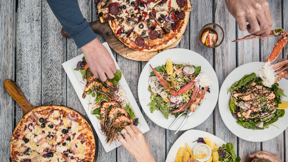 A selection of stone-baked pizza, local seafood and other dishes at Punga Cove in the Marlborough Sounds, New Zealand.