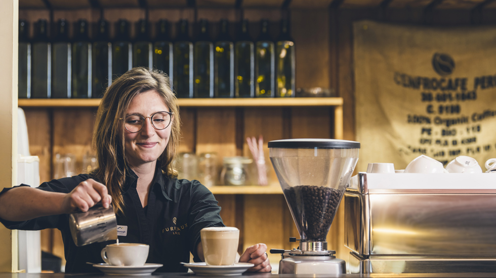 A barista makes coffee at Furneaux Lodge in the Marlborough Sounds, New Zealand.