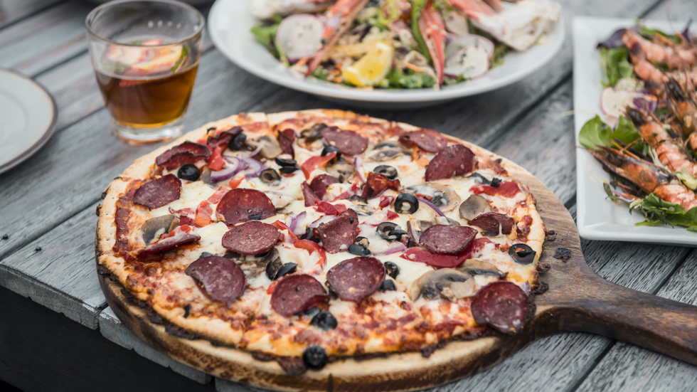 Fresh stone-baked pizza served at Punga Cove in the Marlborough Sounds, New Zealand.