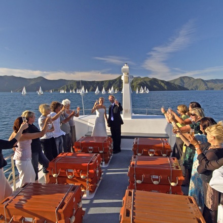 A newly married couple celebrate their wedding in the Marlborough Sounds aboard a Cougar Line boat.